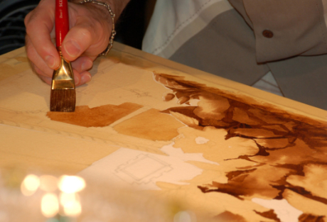 A photo of artist Steven Mikel painting with espresso - Dark Roast Watercolors, Painting with Coffee